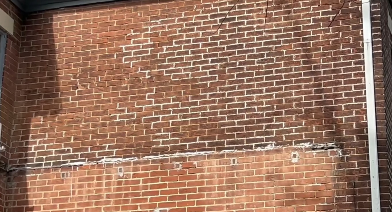 Professional masonry contractors working on brick restoration in Des Moines, IA